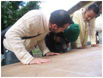 Learners working on a large drawing board